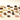 Assorted chocolates and candies of various shapes, colors, and textures are arranged on a light surface, displayed in a neat and minimalist style.
