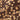 Close-up of a chocolate bar with whole hazelnuts embedded throughout its smooth, dark surface. The nuts are unevenly distributed, giving the chocolate a textured and rich appearance.