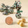 Cream and crunchy Nougatine chocolate with hazelnut bits, three Piedmont IGP hazelnuts, and candies in patterned foil. - AI generated text