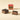 A wrapped Cremino Espresso square beside two pieces revealing the delicate layers of hazelnut and rich coffee blend. - AI generated text