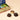 Assorted Chocoviar Vintage Dream Mini Book tin, featuring a selection of chocolates including one with a pistachio center. - AI generated text